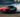 A drift car executing a clean controlled slide through a turn, tire smoke filling the background.