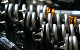 Close up photo of S-Class coilover conversion springs and sway bar laying on a table