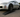 Lightweight split-style race ramps positioned under a lowered drift car in a garage