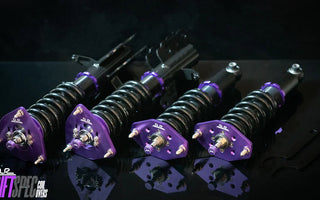 sn95 coilovers laid out on a black table