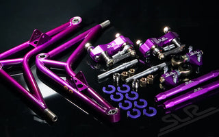 SLRspeed suspension parts laid out including coilovers, camber arms, tie rods, and sway bar links.