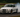 BMW E36 drift car on track with visible angle kit, coilovers, and steering mods