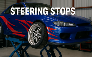 A nissan drift car on a lift with steering stops installed