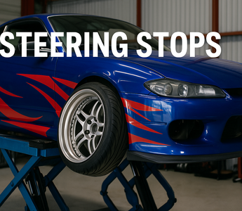 A nissan drift car on a lift with steering stops installed